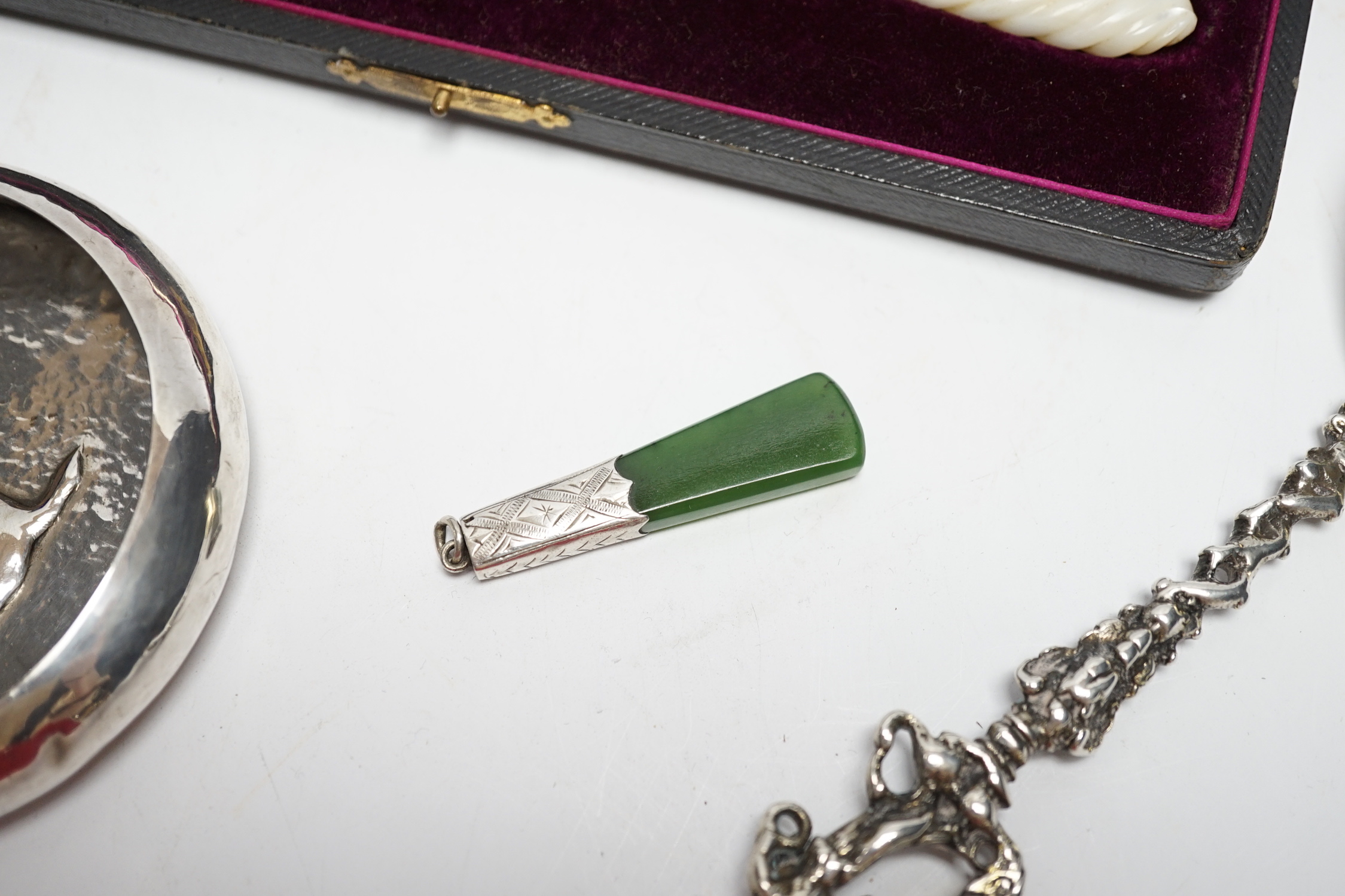 A cased pair of late Victorian mother of pearl handled silver 'berry' spoons, by A.J. Bailey, Birmingham, 1896, a continental white metal spoon with figural terminal, a pierced white metal sugar basket, with blue glass l